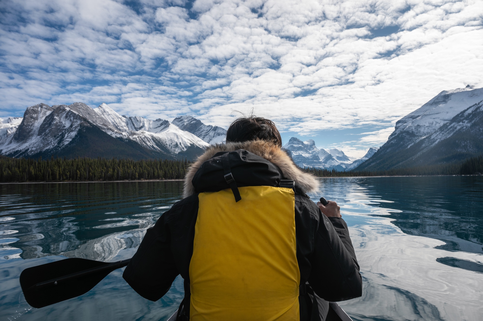 Traveler man canoeing with Canadian Rockies on Maligne lake at Jasper national park
